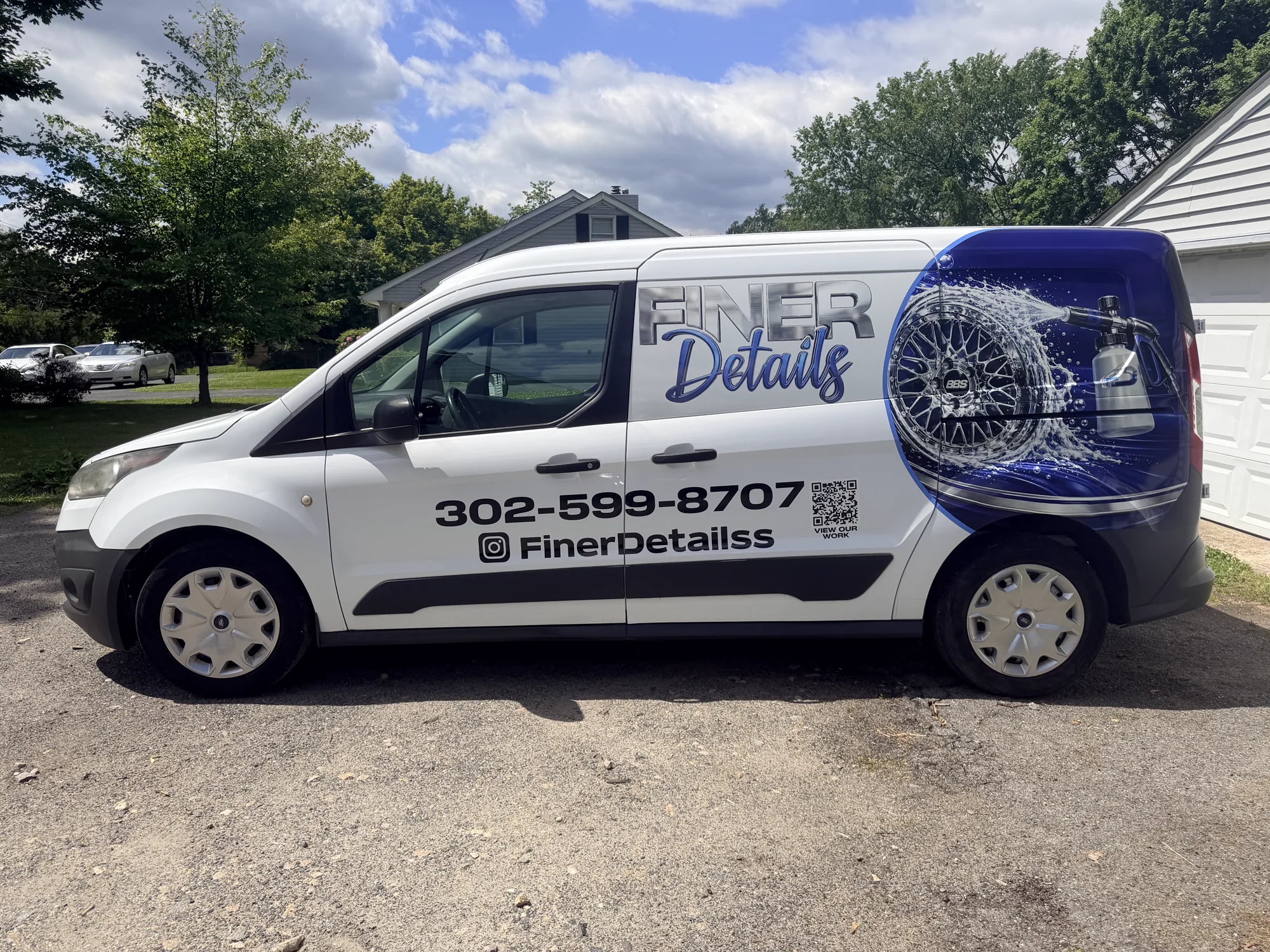 Partial van wrap for Finer Details mobile detailing in Delaware — chrome lettering, full-color wheel graphic, and scan-to-view-work QR code