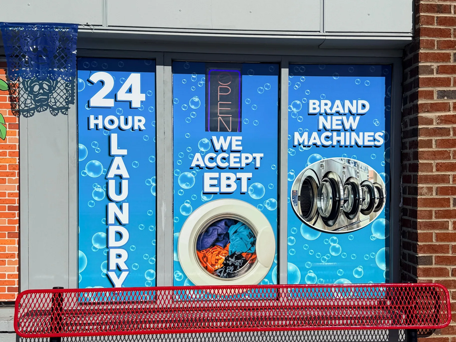Laundromat storefront window graphics after professional installation in Delaware