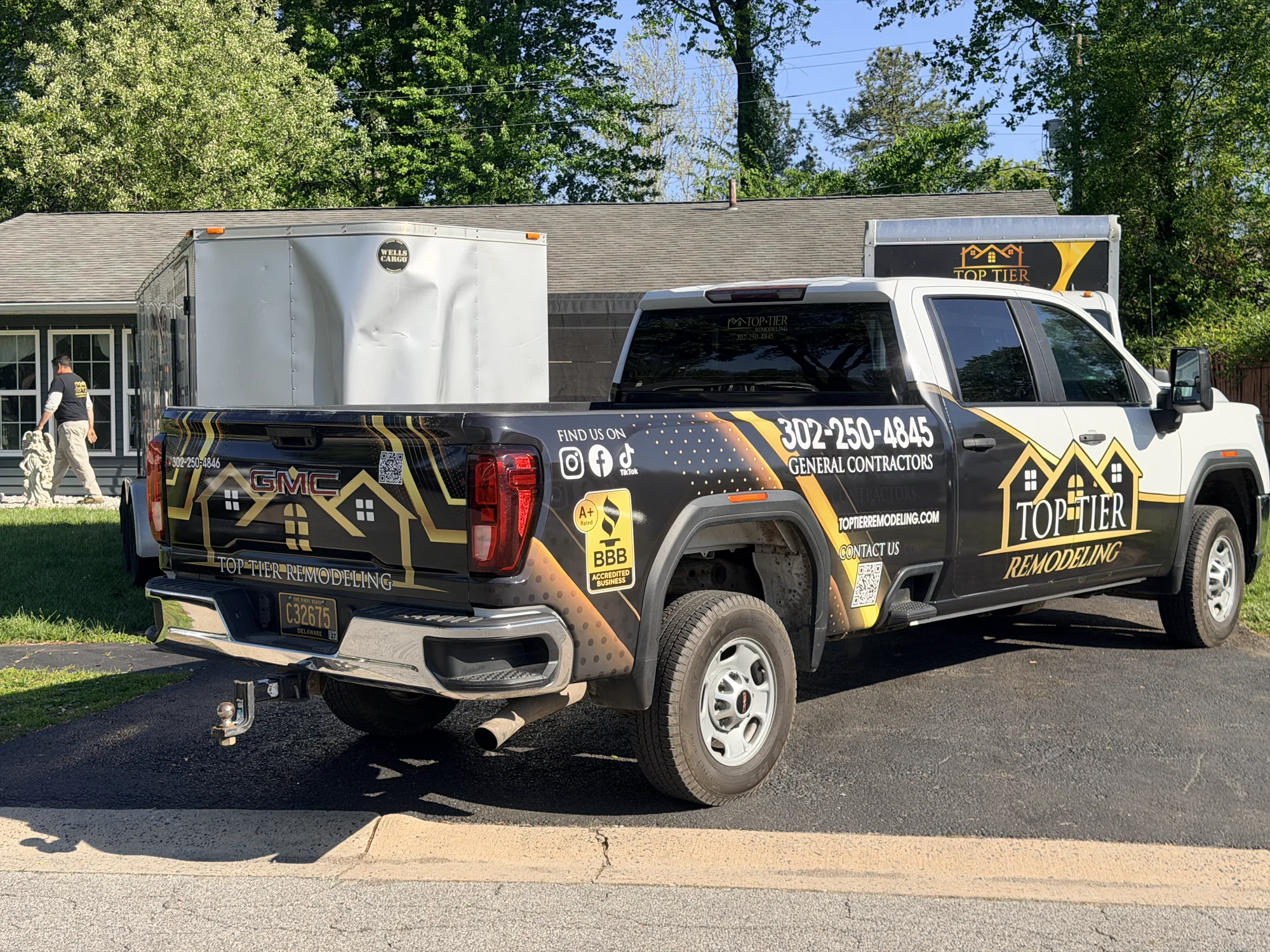 Black-and-gold partial truck wrap for Top Tier Remodeling, Delaware general contractors — bed wrap, tailgate graphics, and social QR codes